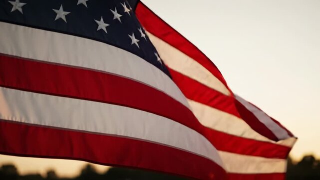 American flag waving in the wind during sunset