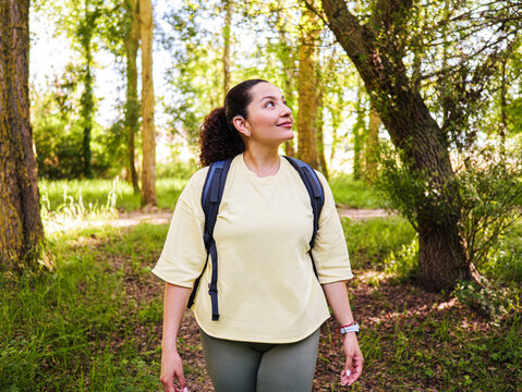 Portrait of a young woman in a park. Deaf disabilty enjoy the nature