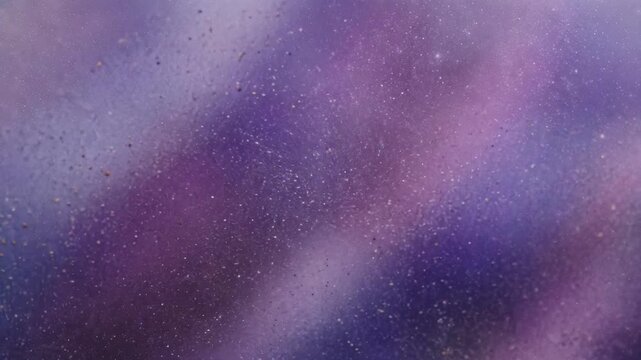 Close-up of purple and violet textured surface with dust particles