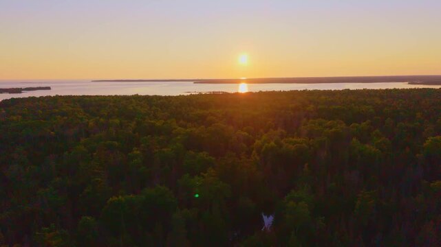 Bruce Penisula, Canada - July 8 2026: A stunning 4K aerial drone view of Singing Sands Beach in the Bruce Peninsula, showcasing shallow turquoise waters, soft sandy shores, and lush coastal forests.