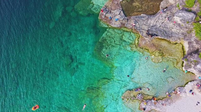Bruce Penisula National Park, Canada - May 8 2026: Rugged limestone cliffs and crystal-clear turquoise waters frame the Georgian Bay shoreline near the famous Grotto in Bruce Peninsula National Park