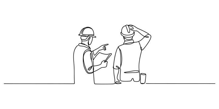 Two construction workers with hard hats talking and pointing at a building project plan