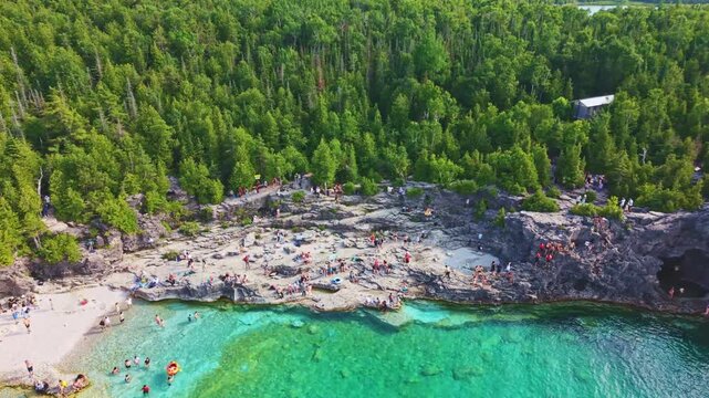 Bruce Penisula National Park, Canada - May 8 2026: Rugged limestone cliffs and crystal-clear turquoise waters frame the Georgian Bay shoreline near the famous Grotto in Bruce Peninsula National Park
