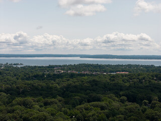 Fototapeta premium Aerial drone view of tree-lined residential neighborhood with detached homes and local streets in Bayberry Park, New Rochelle, New York