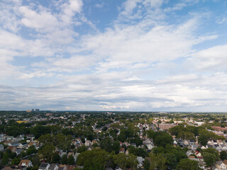 Obraz premium Aerial drone view of tree-lined residential neighborhood with detached homes and local streets in Hollis, Queens, New York City, New York