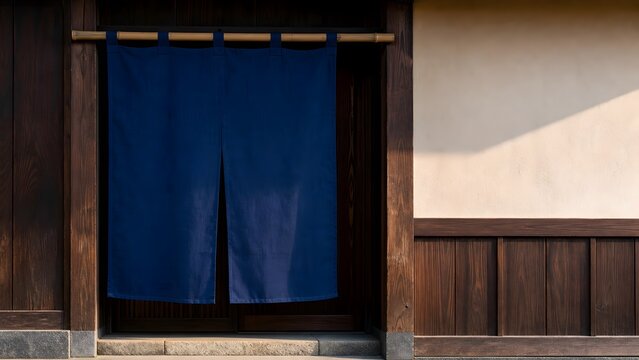 Plain indigo Japanese noren curtain at a traditional wooden entrance