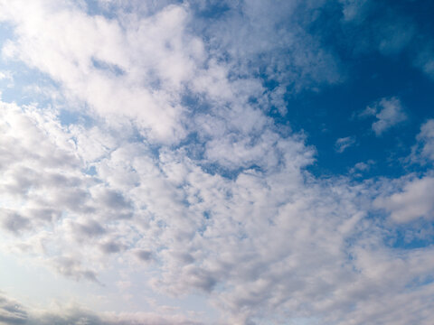 Blue sky with white altocumulus clouds on a clear day