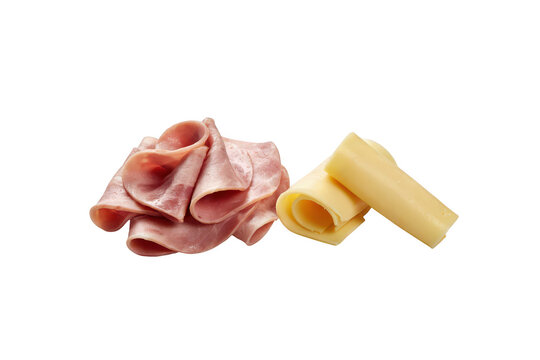 A pile of thinly sliced folded ham next to a rolled slice of yellow cheese, isolated on a black background, for food