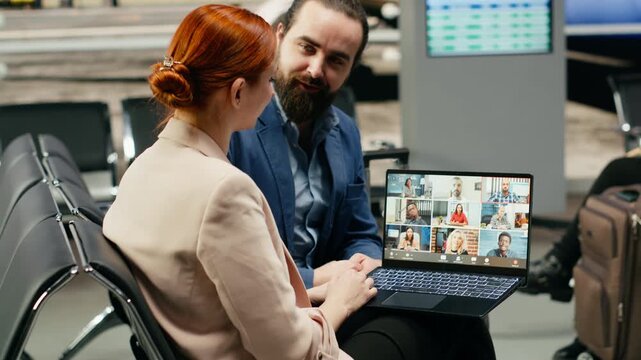 A corporate team uses a laptop for a web conference before departure, engaging with team members and shareholders in a virtual discussion during business travel and remote telemarketing work.