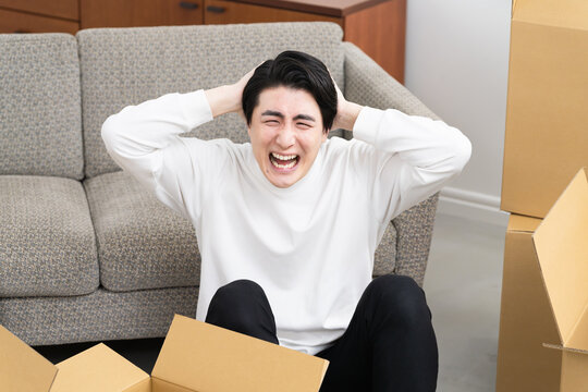引っ越しの準備をする若い男性　ライフスタイルイメージ
