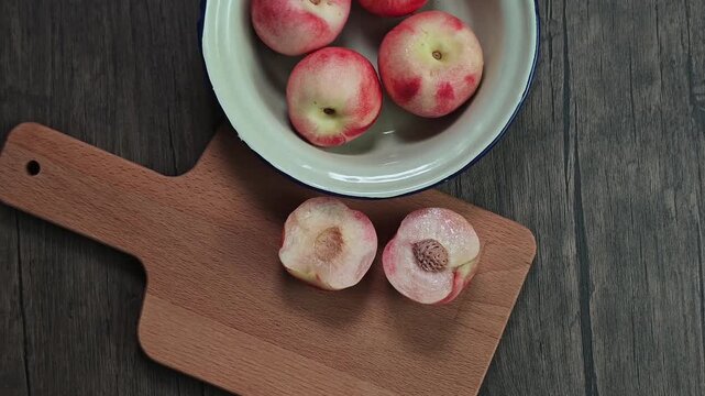 Red apple pink peach fruit whole sliced half seed tin plate chopping board wooded background