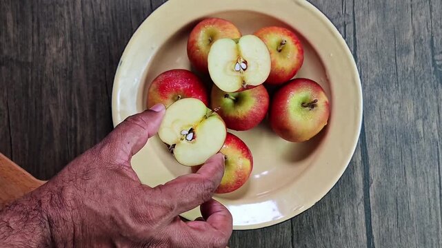 Red apple pink peach fruit whole sliced half seed tin plate chopping board wooded background