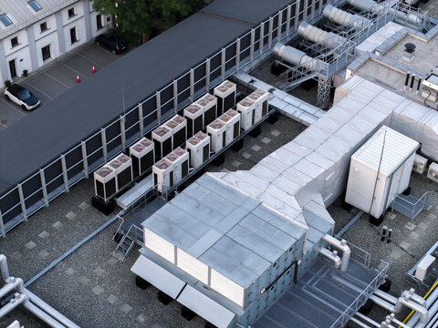 Krakow, Poland - 18 July 2026: Aerial view of data center ai cooling system with rows of industrial air conditioning units and ventilation ducts on a rooftop.