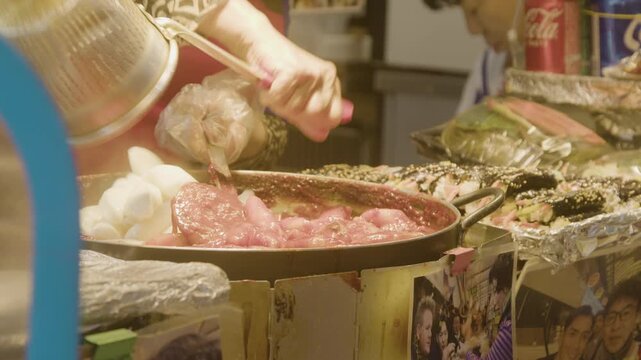 A market vendor cooking tteokbokki at Gwangjang Market, Seoul