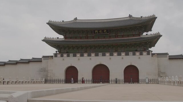 Slow-motion Wide of Pedestrians and Tourists in from of Gwanghwamun Gate