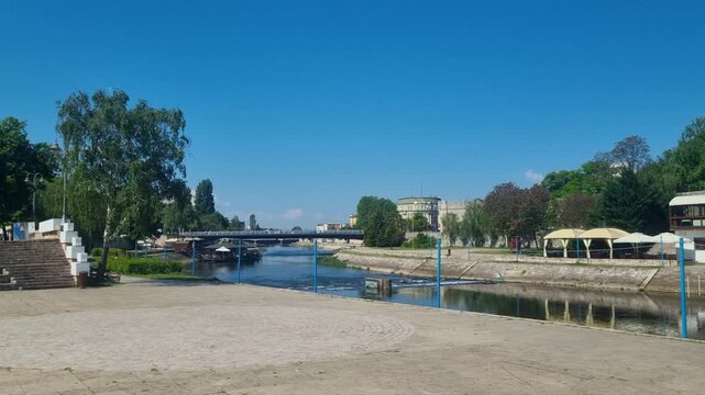 Sunny spring view along the Ni&scaron;ava River in the city center of Ni&scaron;, Serbia, capturing a calm urban atmosphere, blue skies, riverside scenery, and the charm of an underrated Balkan travel destination