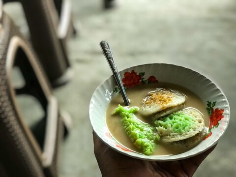 A close-up shot of *serabi ngampin Ambarawa* soup&mdash;a traditional Indonesian dish featuring fermented glutinous rice&mdash;served in a ceramic bowl under natural light.