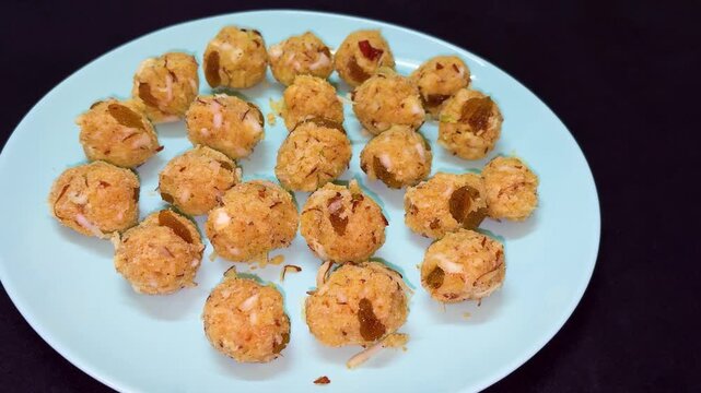 Traditional Indian Besan Ladoo Sweet Garnished With Dry Fruits On Plate Top View