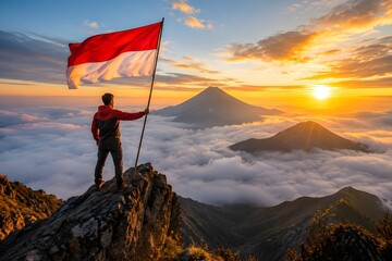 Obraz premium Hiker Holding Indonesian Flag on Mountain Peak at Sunrise Above the Clouds, Symbol of National Pride and Independence. 