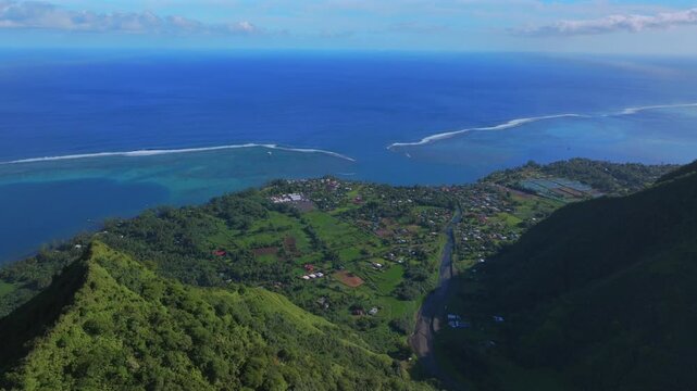 Tahiti Mountain Ridge coastline Teahupo'o South Pacific Ocean French Polynesia aerial drone vibrant sunny morning Teahupo'o lagoon surfing Passe Havea coral reef break waves forward pan up