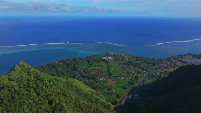 Tara Huhurahi Ridge town of Teahupo'o village South Pacific Ocean Tahiti French Polynesia aerial drone early sunny morning Teahupo'o lagoon surfing Passe Havea coral reef break waves circle left