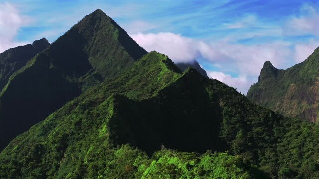 Teahupo'o mountains Tara Huhurahi Ridge South Pacific Island Mount Ronui Aorai Orohena Vaiau River Valley French Polynesia aerial drone Tahiti Ito Volcano afternoon sunny blue sky clouds circle right