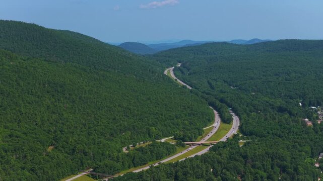 Adirondack Mountains highway Northway cars Lake George aerial drone July Up State New York Town of Lake George landscape harbor view Assembly Point spring summer sunny morning blue sky circle right