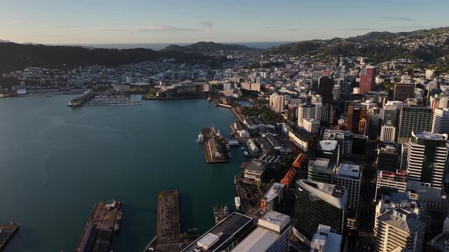 Buildings of Wellington City near the harbor at sunrise, Aerial drone orbit shot