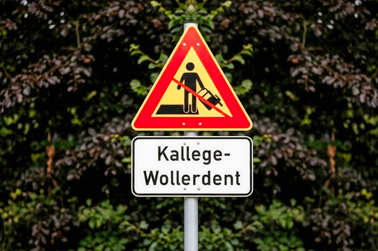 Funny custom road sign with German text and warning symbol