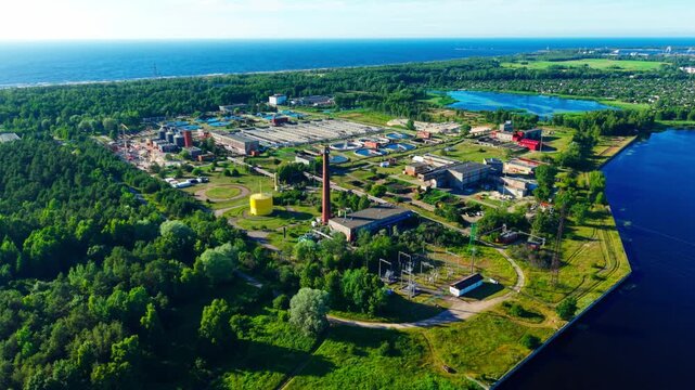 Drone flies forward with tilt down revealing Riga wastewater treatment plant