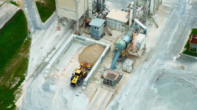 Medium tele aerial view of asphalt plant silos dryers and aggregate loading area