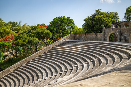 La Romana, Dominican Republic - 22 July 2026: Aerial view of Altos de Chavon Amphitheatre with its stone seating tiers, surrounding lush tropical trees, and clear blue sky.