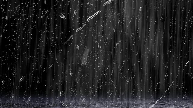 Heavy rain falling down against dark background with bright white lightning flashes illuminating stormy night skies with falling vertically