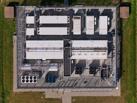 Nordborg, Denmark - 12 July 2026: Aerial view of the Danfoss Campus modular data center, featuring server containers, cooling units, and industrial piping for heat recovery.