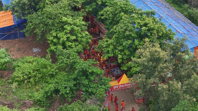 Aerial drone view of Kanwar Yatra pilgrims walking along the sacred route from Sultanganj to Deoghar during Shravan, capturing devotion, crowds, colorful kanwars, and India's largest annual pilgrimage