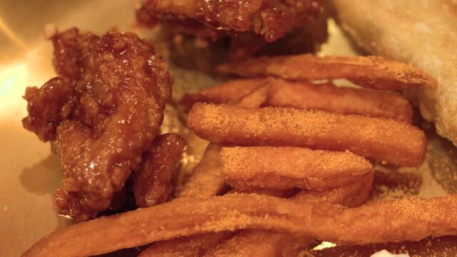 Close Up of Korean Fried Chicken and Seasoned French Fries
