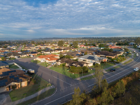 Sunrise casting long shadows of trees over houses in Hunterview a suburb of Singleton