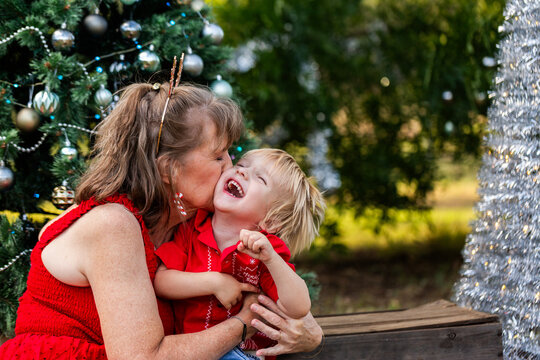 Joyful moment shared between grandmother and young grandson at Christmas family gathering 