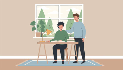 Fototapeta premium Friendly young man supporting his male friend who is studying or working at a desk in a cozy home environment.