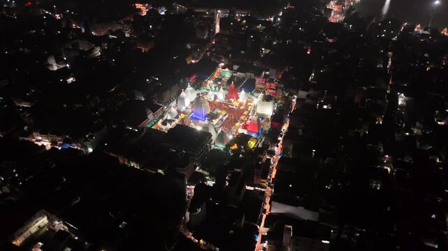 Aerial drone footage of Baba Baidyanath Dham in Deoghar at night, showcasing the illuminated temple complex, glowing city lights, surrounding streets, and the sacred Jyotirlinga pilgrimage site.