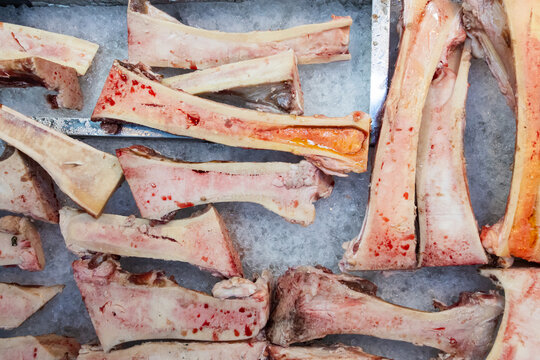 Fresh beef marrow bones arranged as a butcher shop background