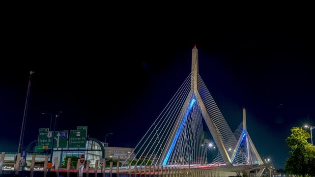 Timelapse of Zakim Bridge illuminated at night with blue lights.