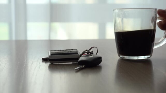 A Tranquil Moment Captured: Coffee and Keys on a Table Bathed in Soft Light, Evoking a Sense of Calm and Reflection in a Minimalist Setting