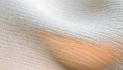 Fototapeta premium Soft White Cotton Fabric Texture Featuring Gentle Folds and Warm Sunlight Glow Abstract Background