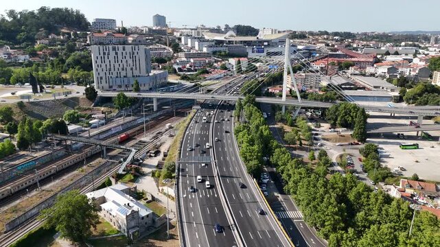 Porto, Portugal - 27 July 2026: Aerial view of the highway and cable-stayed bridge near Estadio do Dragao with surrounding urban infrastructure.