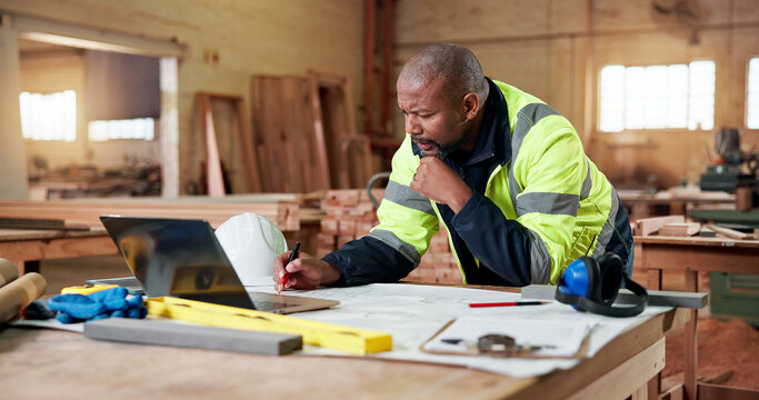Carpentry, thinking and writing with black man in workshop for agenda, checklist or online order. Computer, documents and planning with mature carpenter in woodworking factory for digital schedule