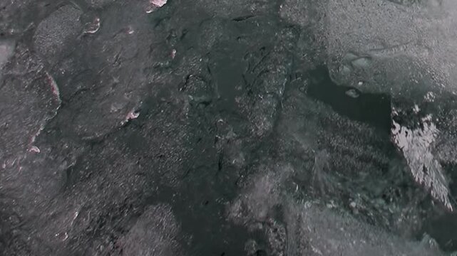 An aerial exploration of the frozen Arctic Ocean in winter. Massive ice floes and treacherous open water create a challenging landscape for extreme travel.