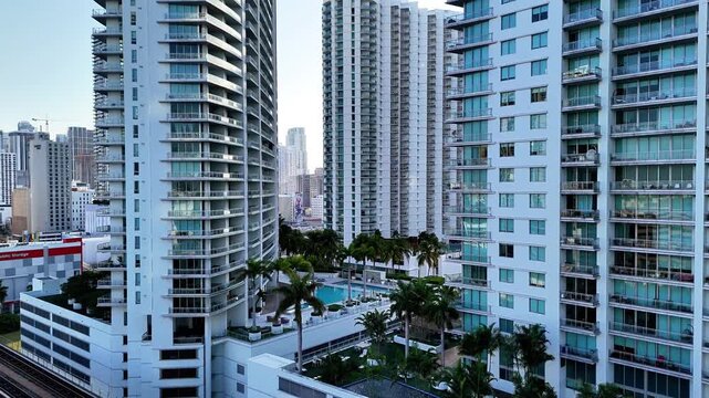 Miami, Florida, United States - 10 July 2026: Aerial view of modern high-rise residential buildings with glass balconies and a swimming pool area in the city center.