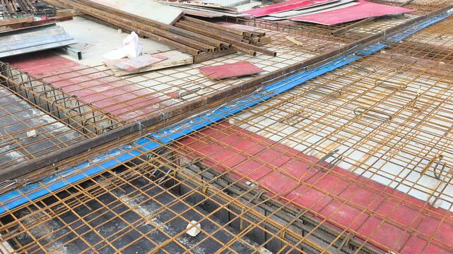 A blue rubber waterstop is installed along a concrete slab construction joint. It acts as a barrier to prevent water ingress through roof slab joints. The fitting ensures structural waterproofing.