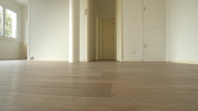 Modern empty apartment interior, white walls, clean wooden floor, bright natural light